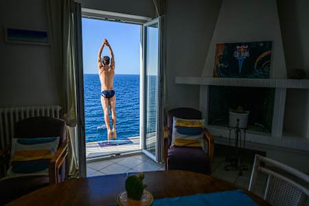 Andrea Barnaba of Italy leaps from a 26m balcony during the third stop of the 2024 Red Bull Cliff Diving World Series in Polignano a Mare, Italy, capturing pure adrenaline on June 28, 2024