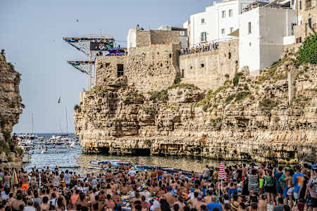Elisa Cosetti of Italy dives from the 21.5 metre platform during the final competition day of the third stop of the 2024 Red Bull Cliff Diving World Series in Polignano a Mare, Italy 