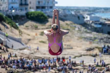 Australian diver Rhiannan Iffland performs an incredible dive from a 21-metre platform during the 2025 Red Bull Cliff Diving World Series in Polignano a Mare, Italy