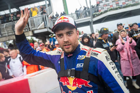 Conor Shanahan raises his hand in celebration after winning Round 3 of the Drift Masters European Championship in Alahärmä, Finland, in 2025.
