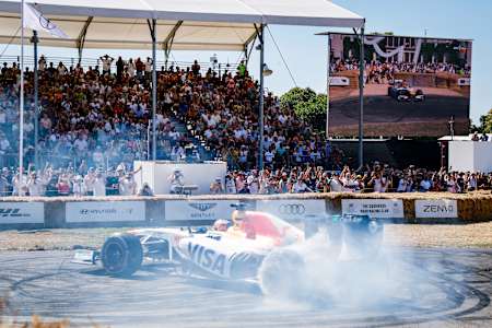 Patrick Friesacher driving the Red Bull Racing-Renault RB8 does donuts during the Goodwood Festival of Speed at Goodwood on July 12, 2025 in Chichester, England.