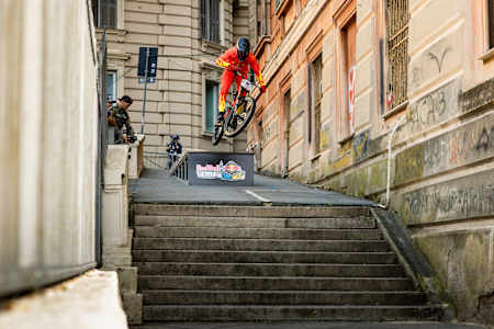Stairs, speed and savage: Sancez Camilio catches air during Red Bull Genova Cerro Abajo 2024 in Genoa, Italy, showcasing his supercharged urban downhill skills