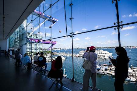 Spectators watch as Scott Lazeroff of the USA performs a high dive from the 27 metre platform during the final stop of the Red Bull Cliff Diving World Series 2025 in Boston harbour