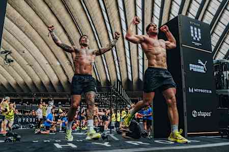 (L-R) Jake Dearden and Marc Dean cross the finish line and take the win in relay category at the Hyrox World Championship in Nice, France, on June 9, 2024. 