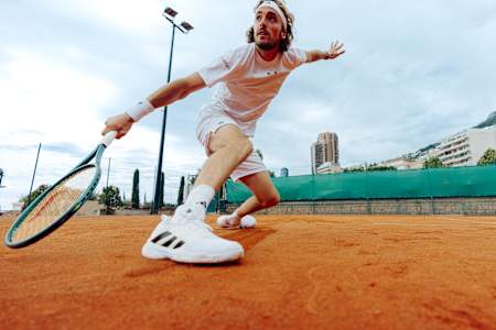 Stéfanos Tsitsipás slidet während eines Tennismatches auf Sand.