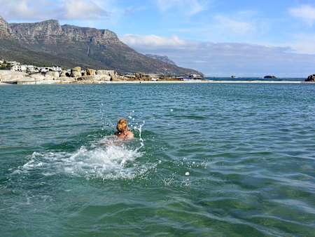 A swimmer in the water at Camps Bay, Cape Town, South Africa.