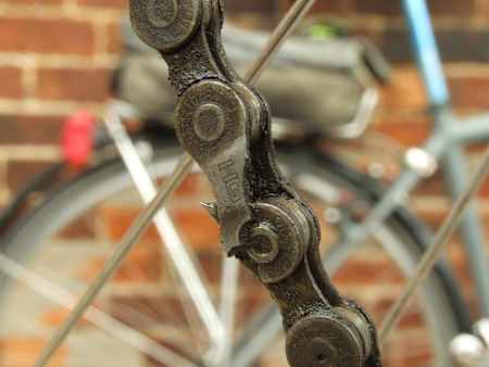A broken chain seen up close on a city bike.