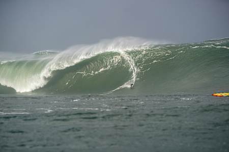 Ireland's Conor Maguire surfs down a giant wave in the wake of Hurricane Epsilon.
