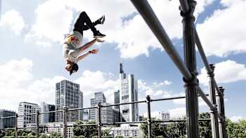 An image of freerunner Jason Paul upside down mid-air in Frankfurt, Germany