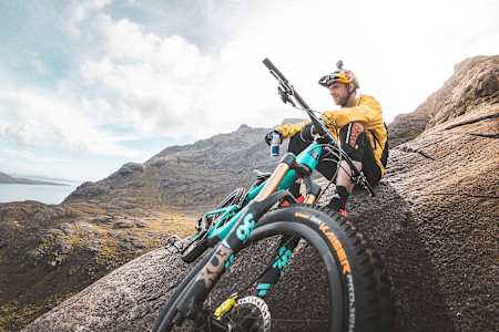 Danny MacAskill drinking a Red Bull on Dubh Slabs, Isle of Skye