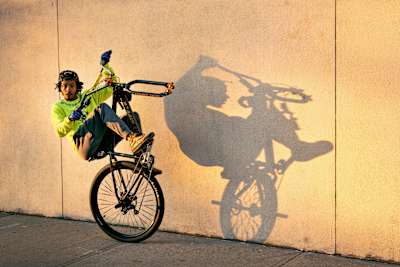 Milez rides with only one wheel on his bike.