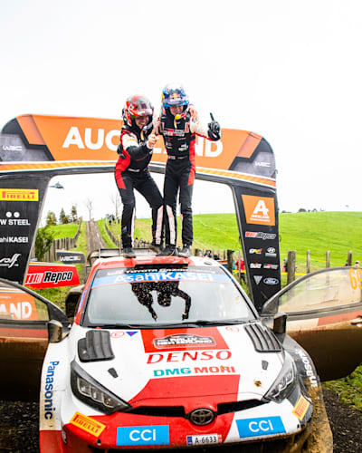 Kalle Rovanpera and Jonne Halttunen of team Toyota Gazoo Racing celebrate on the podium after winning their maiden FIA World Rally Championship title in Auckland, New Zealand.