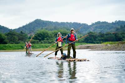 A Canadian squad tentatively floats downstream on tipsy rafts on the fourth day of the adventure race.