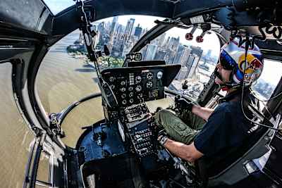 Red Bull Aerobatic Helicopter Pilot, Aaron Fitzgerald, performs flips, barrel rolls and nose dives over the New York City skyline during the morning hours on May 18th 2019. 