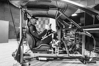 Shane van Gisbergen sitting in a simulator for NASCAR