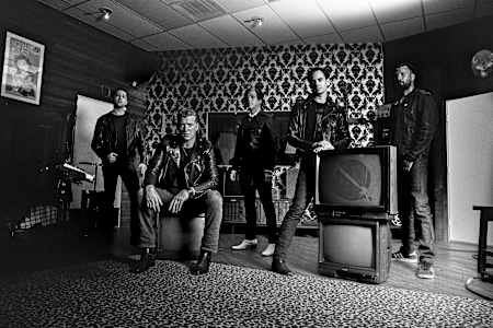 Queens Of The Stone Age pose for a portrait for The Red Bulletin