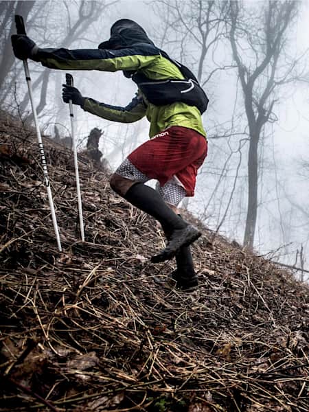 A photograph of two runners taking part in The Barkley Marathons in the woods of Tennessee.