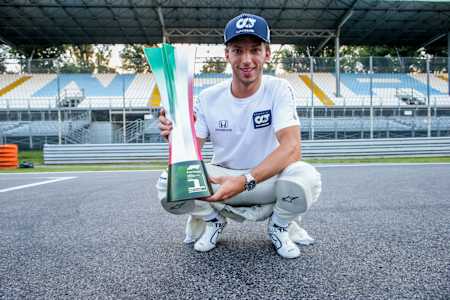 Pierre Gasly ze Scuderii AlphaTauri na prostej startowej toru Monza z pucharem za zwycięstwo w wyścigu F1 o GP Włoch