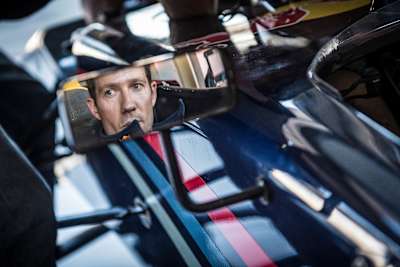 A photo of WRC champion Sébastien Ogier looking in his rear-view mirror before a Formula Renault 3.5 race in Spielberg, Austria in 2017.