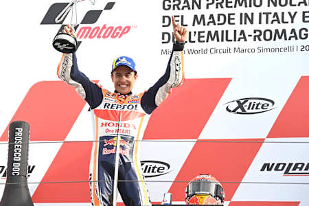 Marc Márquez lifts the winner's trophy at Misano after his victory at the Emilia Romagna MotoGP.