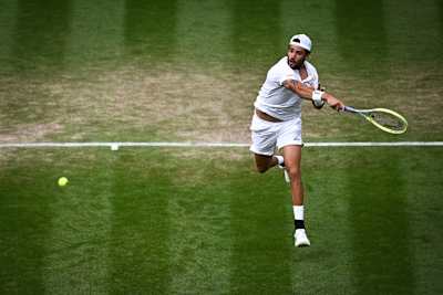 Italy's Matteo Berrettini returns the ball to Germany's Alexander Zverev during their men's singles tennis match at the 2023 Wimbledon Championships.