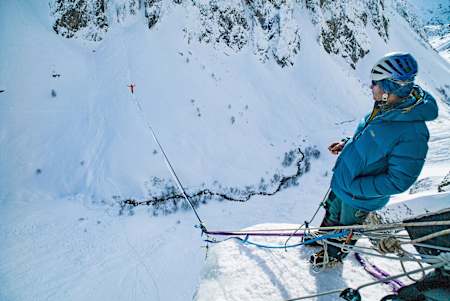 Pablo Signoret is seen on the ice while Lukas Irmler walks on their slackline.
