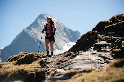 Person hikes over a high-altitude mountain pass in Austria.