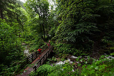 A couple run on a trail near the River Sill in the Innsbruck region.