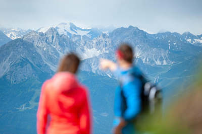Hikers point to the Kalkkögel mountain chain in Innsbruck.