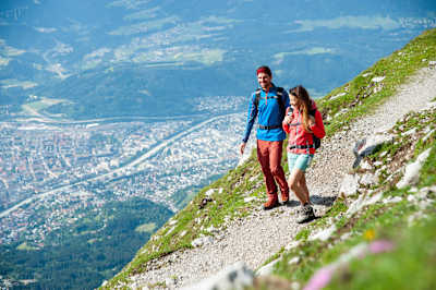 A couple hike in the mountains above Innsbruck.