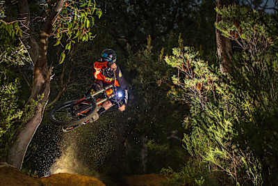 Tim Hughes rides at night on his bike.