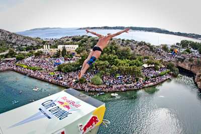 Artem Silchenko of Russia dives from the 26.8-metre platform during the third stop of the Red Bull Cliff Diving World Series at Lake Vouliagmeni in Athens, Greece on May 22, 2011. 