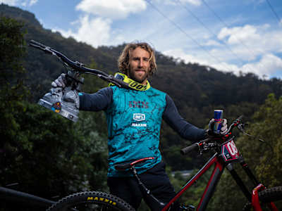 Adrien Loron holds his bike up to the camera