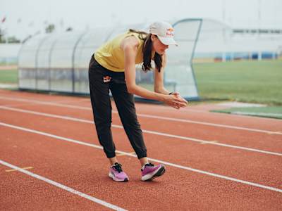 Yaroslava Mahuchikh gears up in Red Bull apparel for a dynamic training session on the Monte Gordo track in Portugal, showcasing athleticism and Red Bull spirit in June 2025.