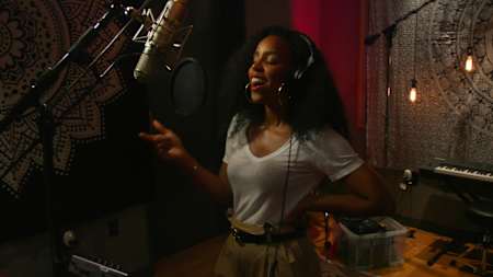 A photo of Kelly Rowland singing into a mic at Red Bull Studios in Santa Monica, California.