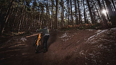 Alan Milway pushing MTB up hill