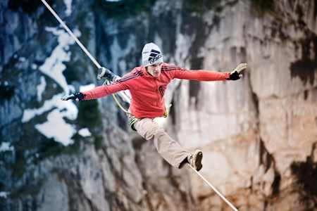 Lukas Irmler balances on a highline over the Wilder Kaiser.