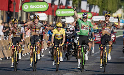 Team Jumbo-Visma crossing the finish line together to celebrate the victory of overall leader Jonas Vingegaard and points Leader Wout van Aert at the end of stage 21 in Paris.