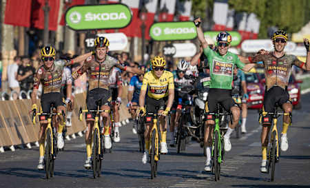 Wout van Aert celebrates with his team Jumbo-Visma after Danish cyclist Jonas Vingegaard secures the general classification of the 2022 Tour de France.