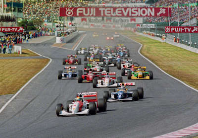 An image of Ayrton Senna and Alain Prost lead the pack at the 1993 Japanese Grand Prix.
