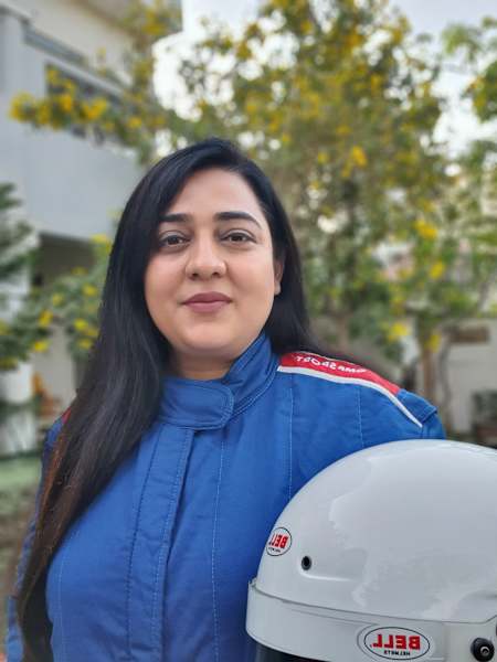 Rally driver Amandeep Kaur is seen with her helmet.