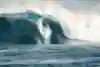 Kai Lenny surfs a huge wave at Peahi in Maui.