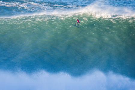 Lucas Chianca takes the drop while surfing at Nazaré in Portugal