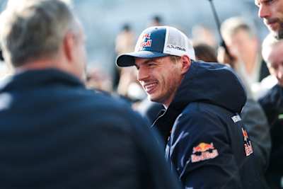 Max Verstappen shares a joke away from the track at the Nürburgring in March 2026.