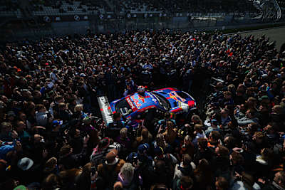 Crowds surround Max Verstappen's AMG Mercedes at the Nurburgring in March 2026.