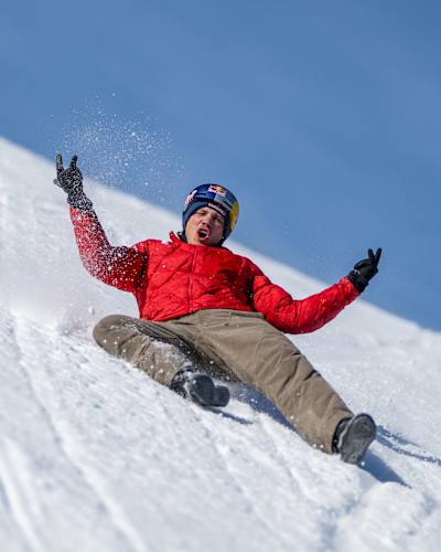 Freerunner Jason Paul gestures to the camera as he slides down the Streif on his back in Kitzbühel, Austria on January 17, 2026.