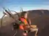 British explorer Ross Turner paragliding across barren landscape in Australia.