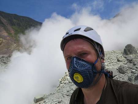 Grzegorz Gawlik takes a photo at the top of a volcano.