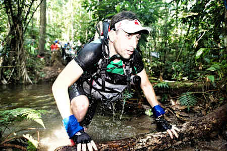 Die Teilnehmer des Jungle-Marathons durchqueren einen Fluss