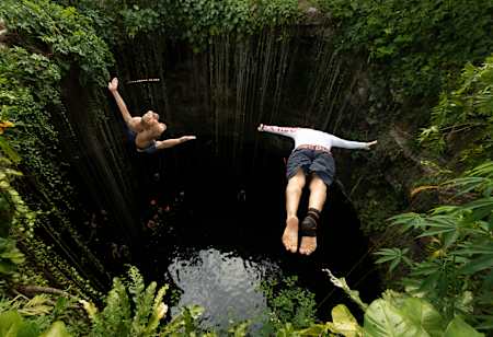 Orlando Duque and Jonathan Paredes jump into the Cenote Ik Kil in Mérida, Yucatán, Mexico on December 2, 2020.